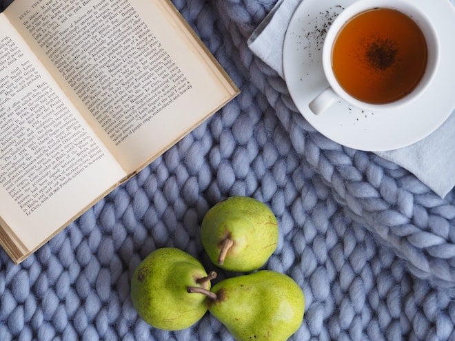 self care scene with pears, tea, and a book
