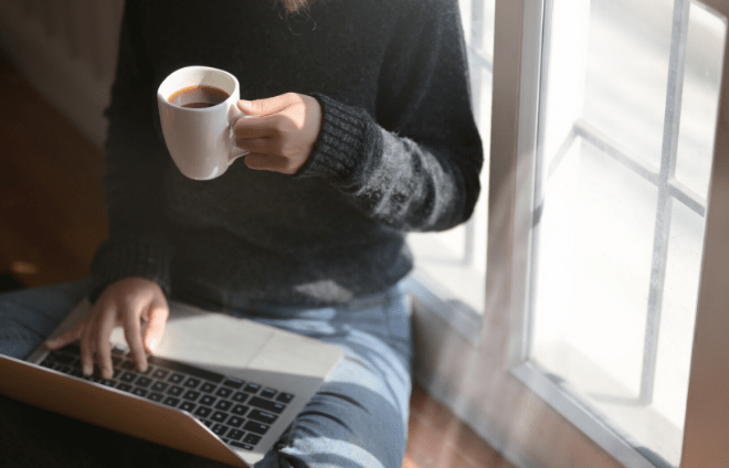 man with coffee and laptop